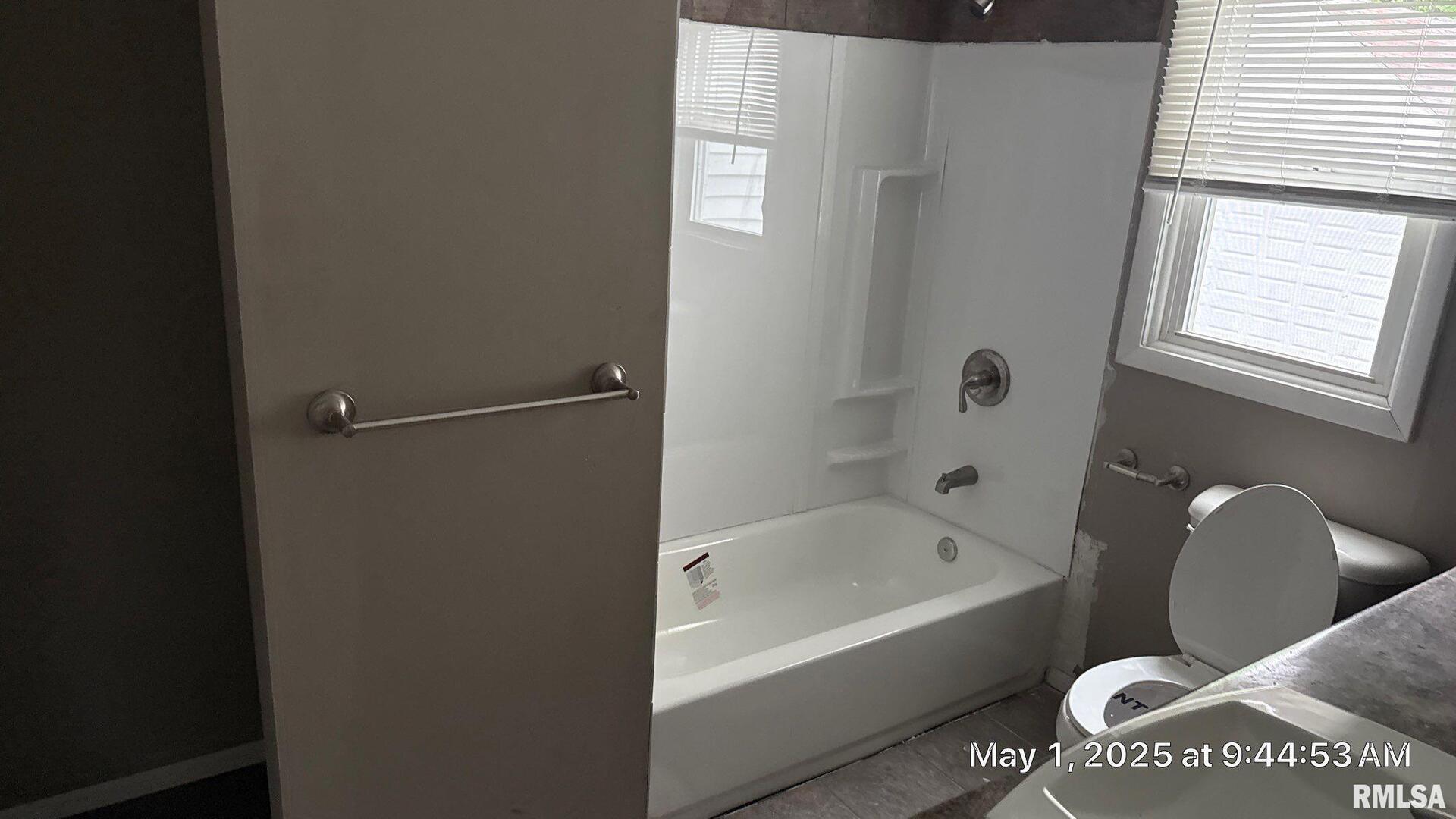 818 9th Avenue Silvis, IL 61282 - Photo 5 of 10 a white bath tub sitting next to a toilet