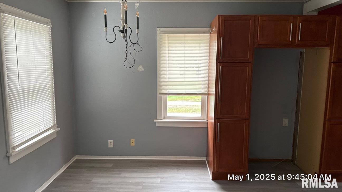 818 9th Avenue Silvis, IL 61282 - Photo 8 of 10 a view of an empty room with wooden floor and a window