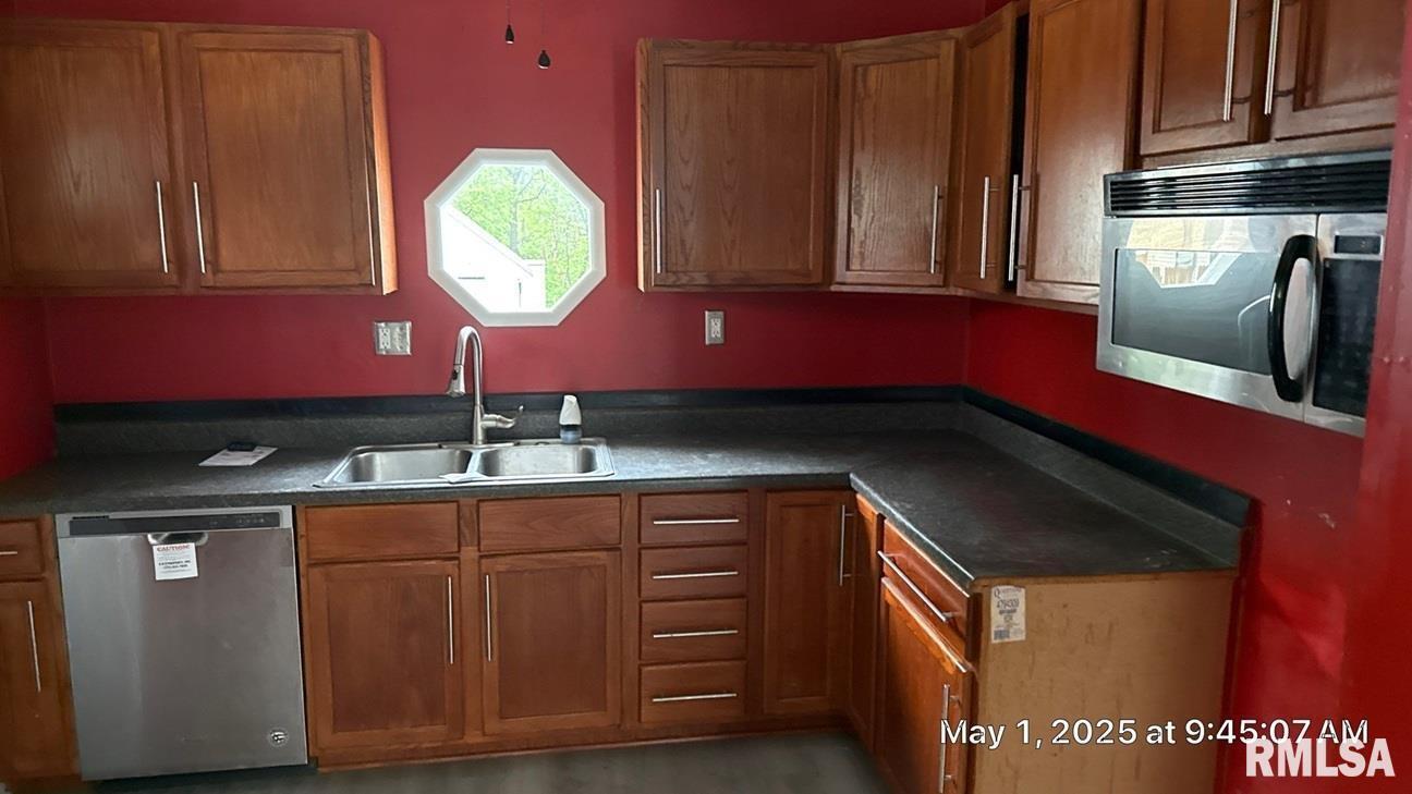 818 9th Avenue Silvis, IL 61282 - Photo 10 of 10 a kitchen with kitchen island granite countertop a sink stainless steel appliances and cabinets