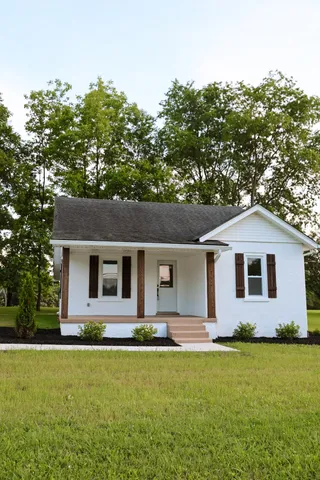 a front view of house with yard and green space