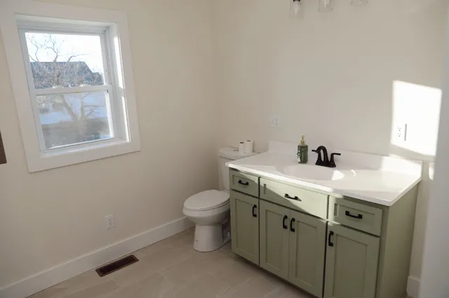 a spacious bathroom with a toilet sink and window