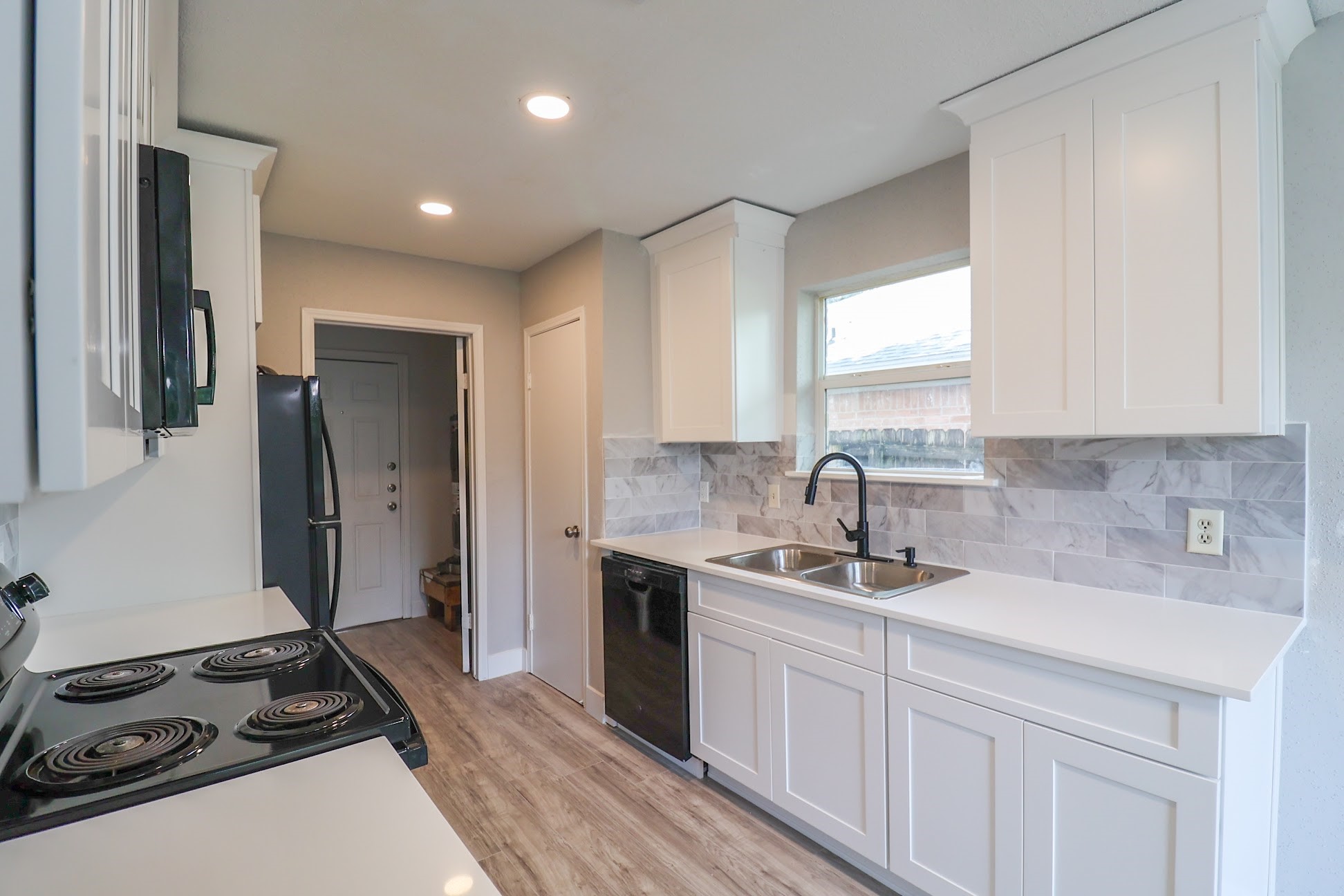a kitchen with a sink stove and refrigerator