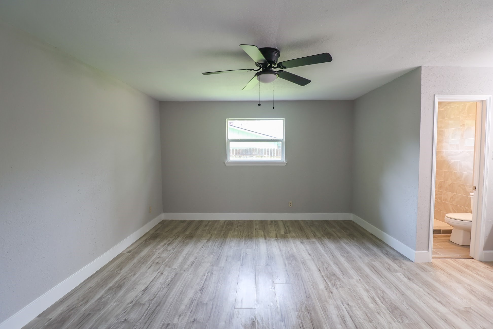 5027 Monteith Drive Spring, TX 77373 - Photo 13 of 28 wooden floor in an empty room with a window
