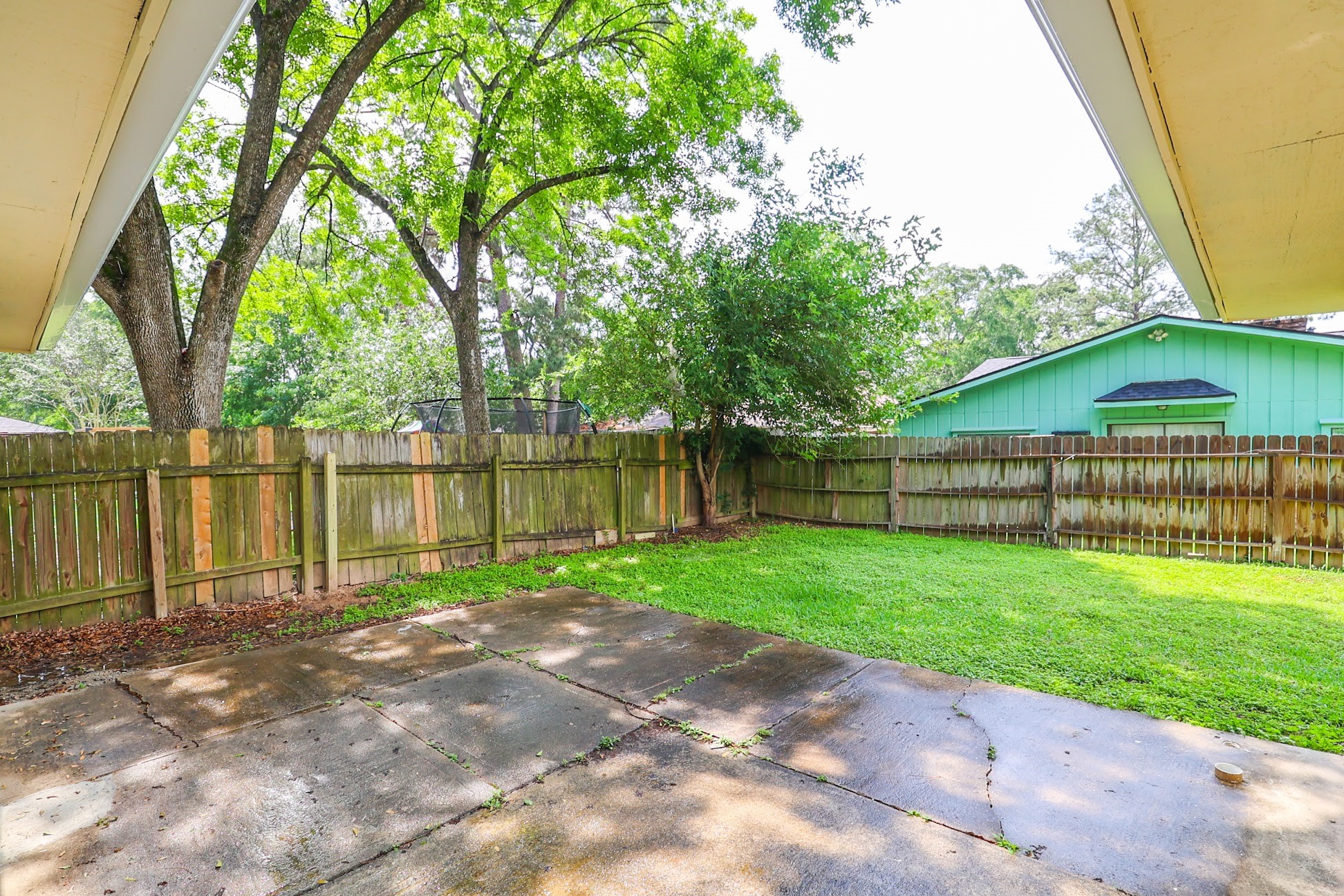 5027 Monteith Drive Spring, TX 77373 - Photo 20 of 28 a view of a backyard with water fountain and large trees