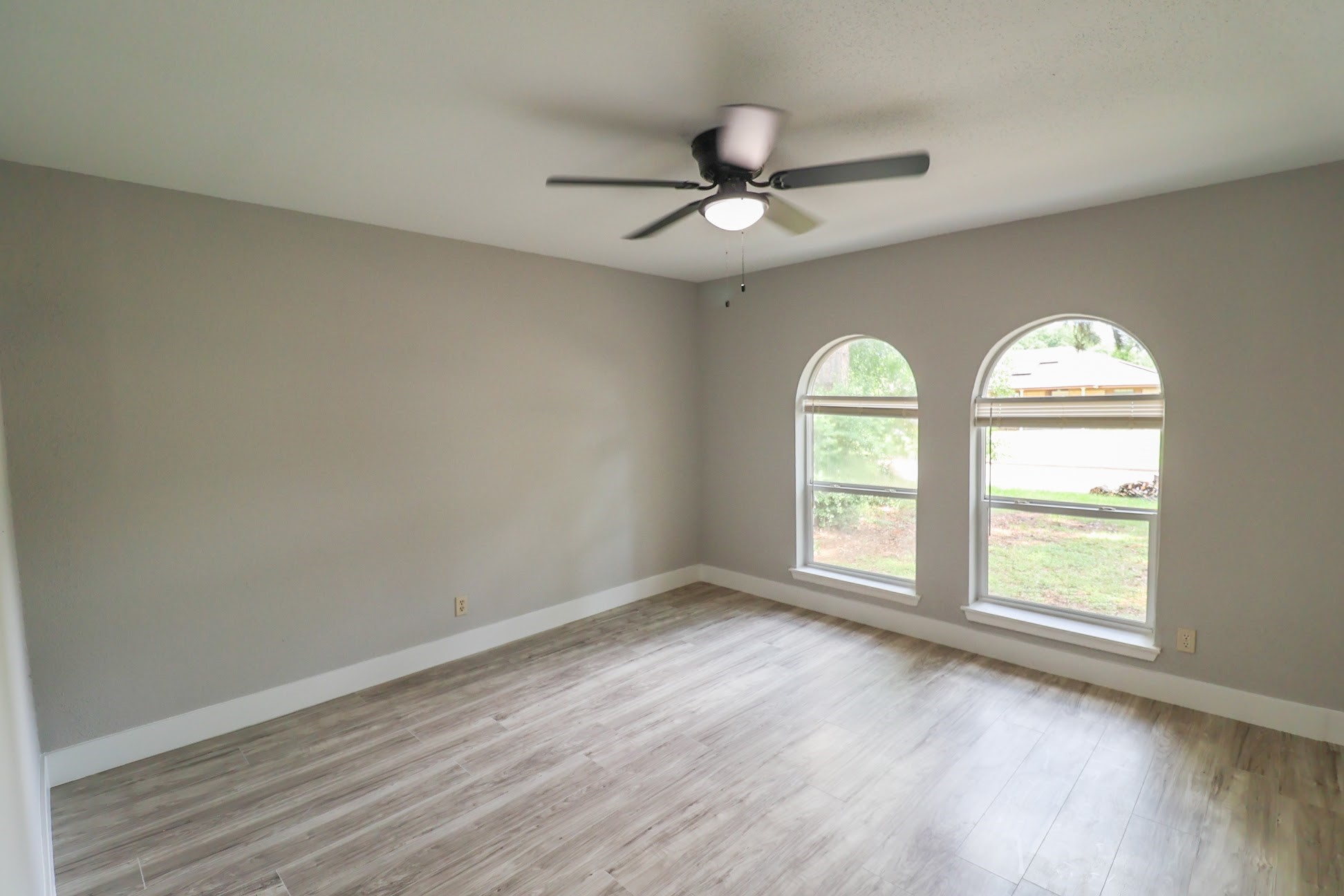 5027 Monteith Drive Spring, TX 77373 - Photo 4 of 28 an empty room with wooden floor fan and windows