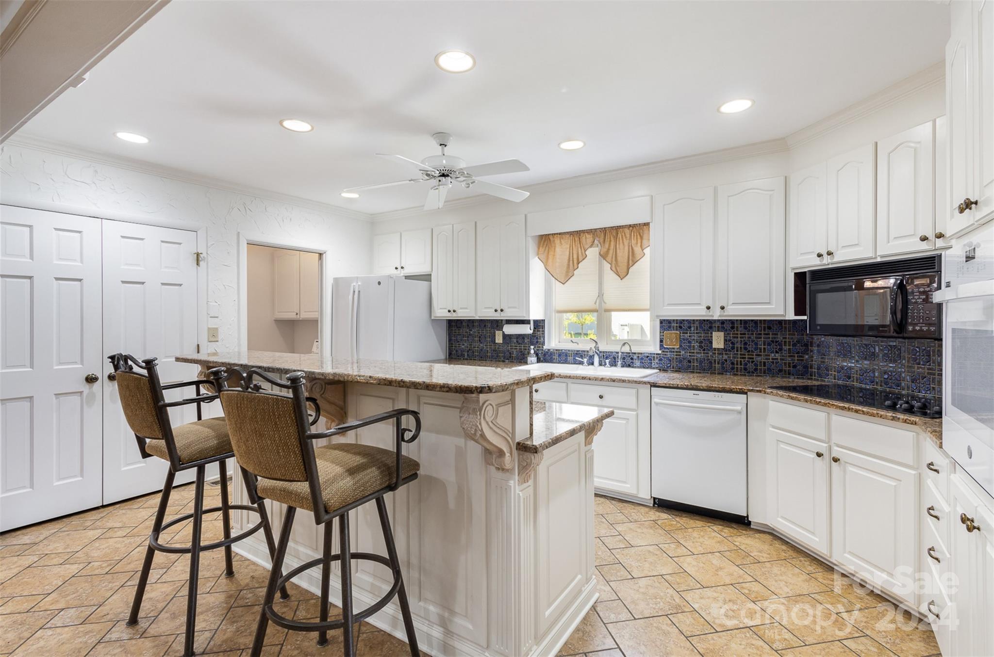 3524 Highview Road Charlotte, NC 28210 - Photo 18 of 34 a kitchen with granite countertop white cabinets a counter top space and stainless steel appliances