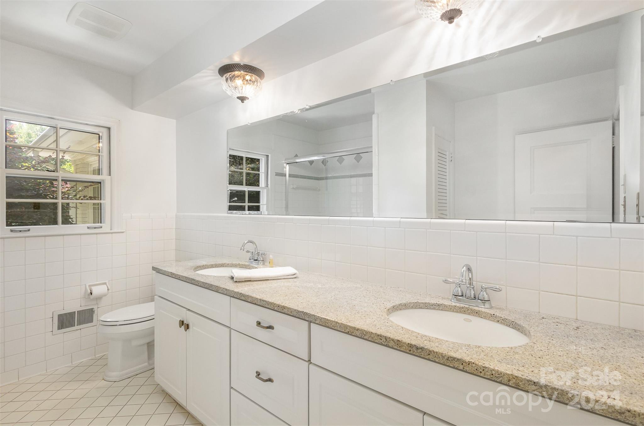 3524 Highview Road Charlotte, NC 28210 - Photo 20 of 34 a bathroom with a granite countertop double vanity sinks and a mirror