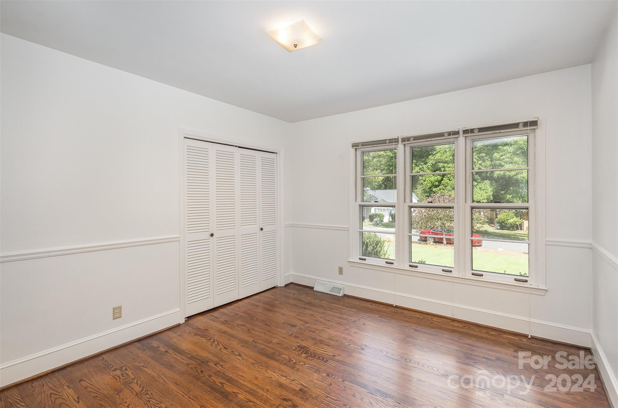 3524 Highview Road Charlotte, NC 28210 - Photo 23 of 34 an empty room with wooden floor and windows