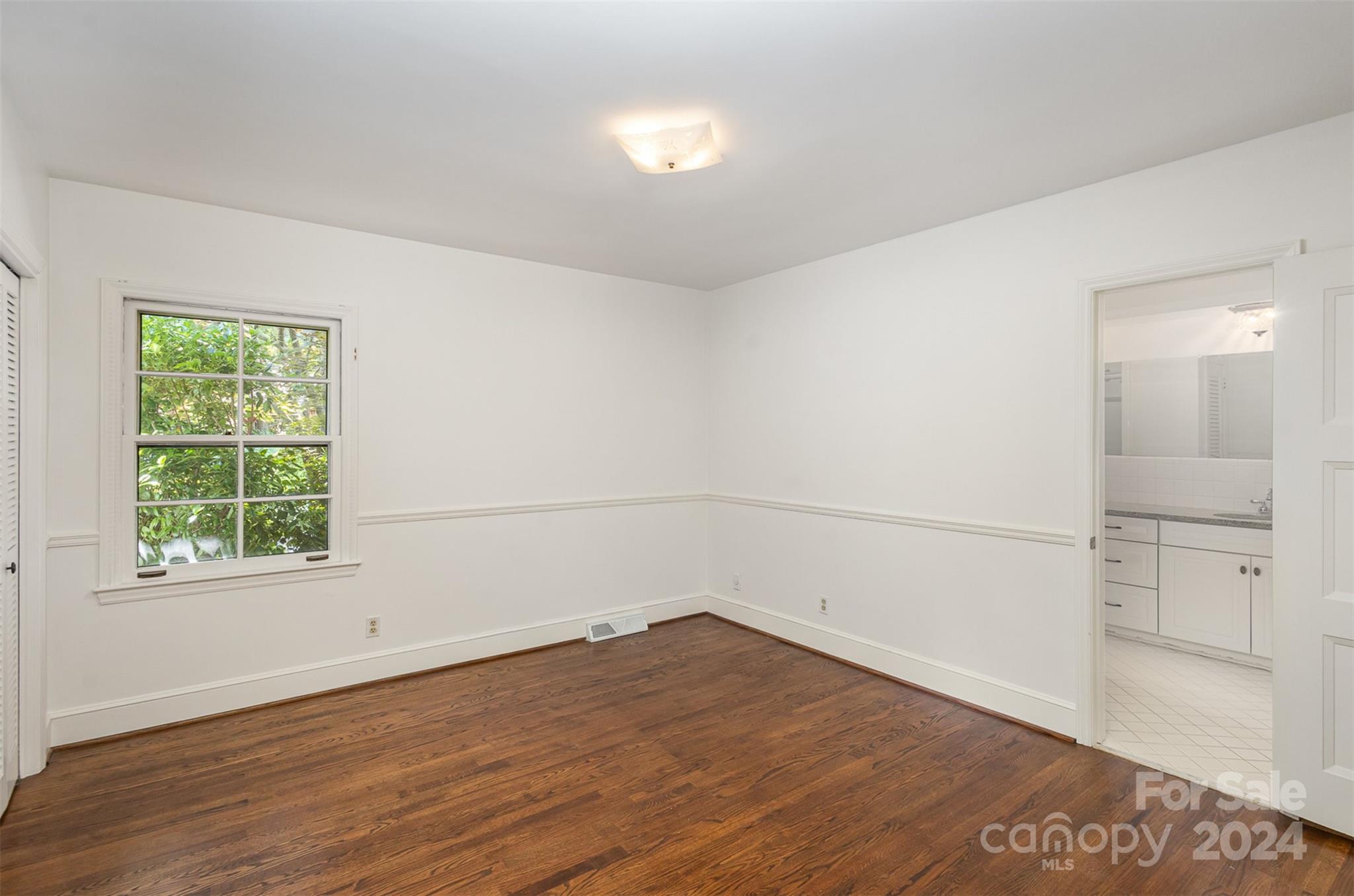 3524 Highview Road Charlotte, NC 28210 - Photo 24 of 34 an empty room with wooden floor and windows