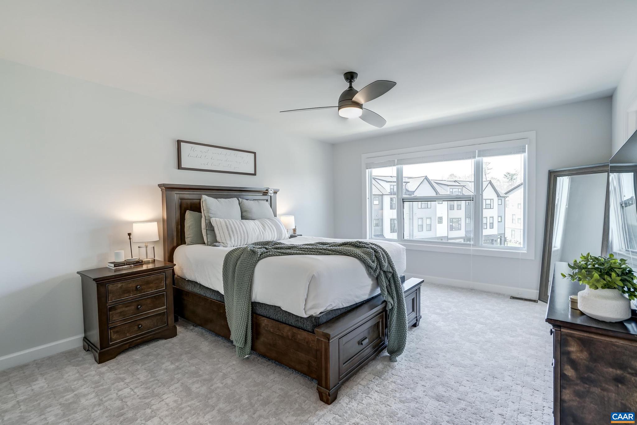 1816 Fowler Street Charlottesville, VA 22901 - Photo 22 of 51 a bedroom with a bed next to a window and a chandelier