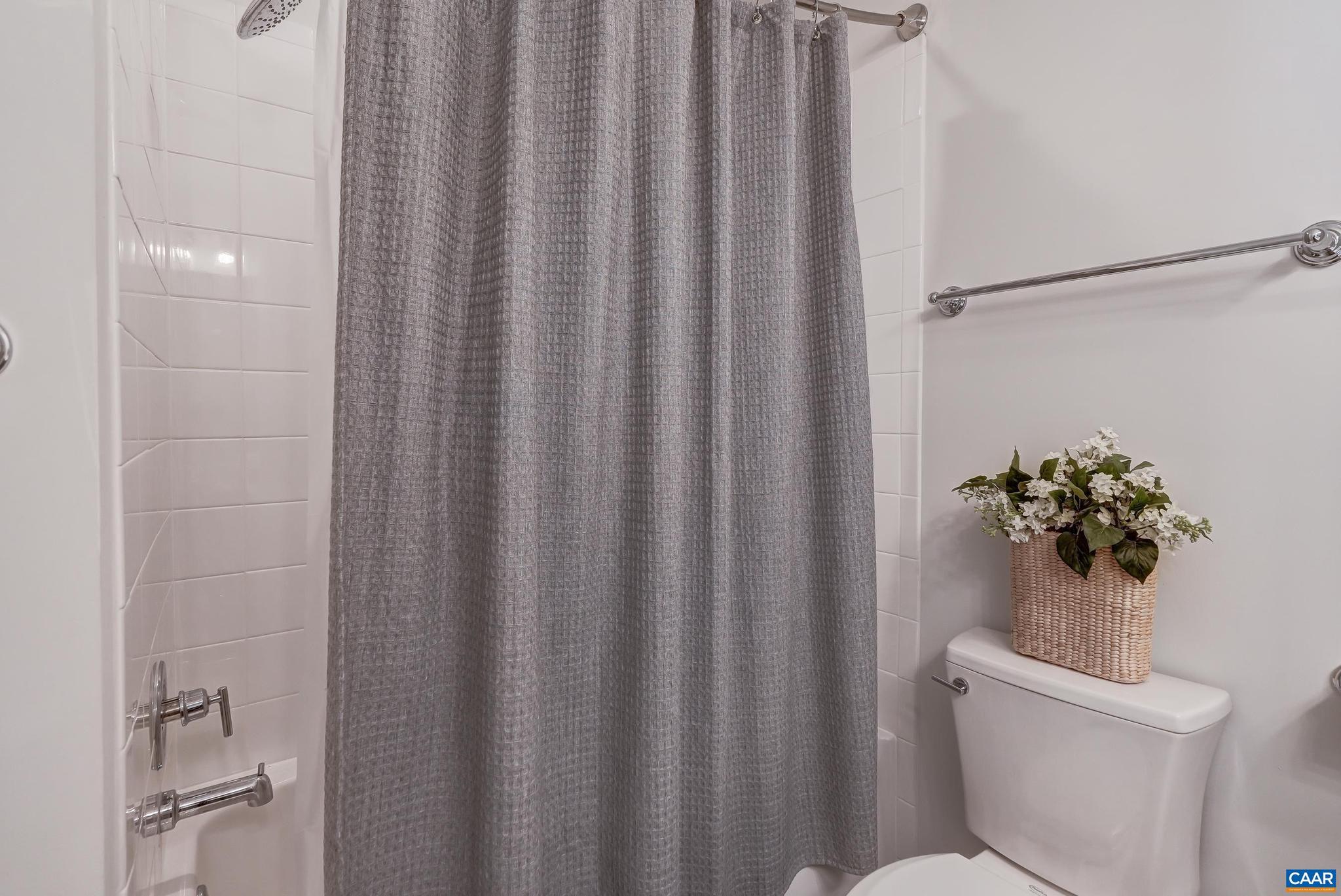 1816 Fowler Street Charlottesville, VA 22901 - Photo 29 of 51 a white toilet sitting next to a shower curtain