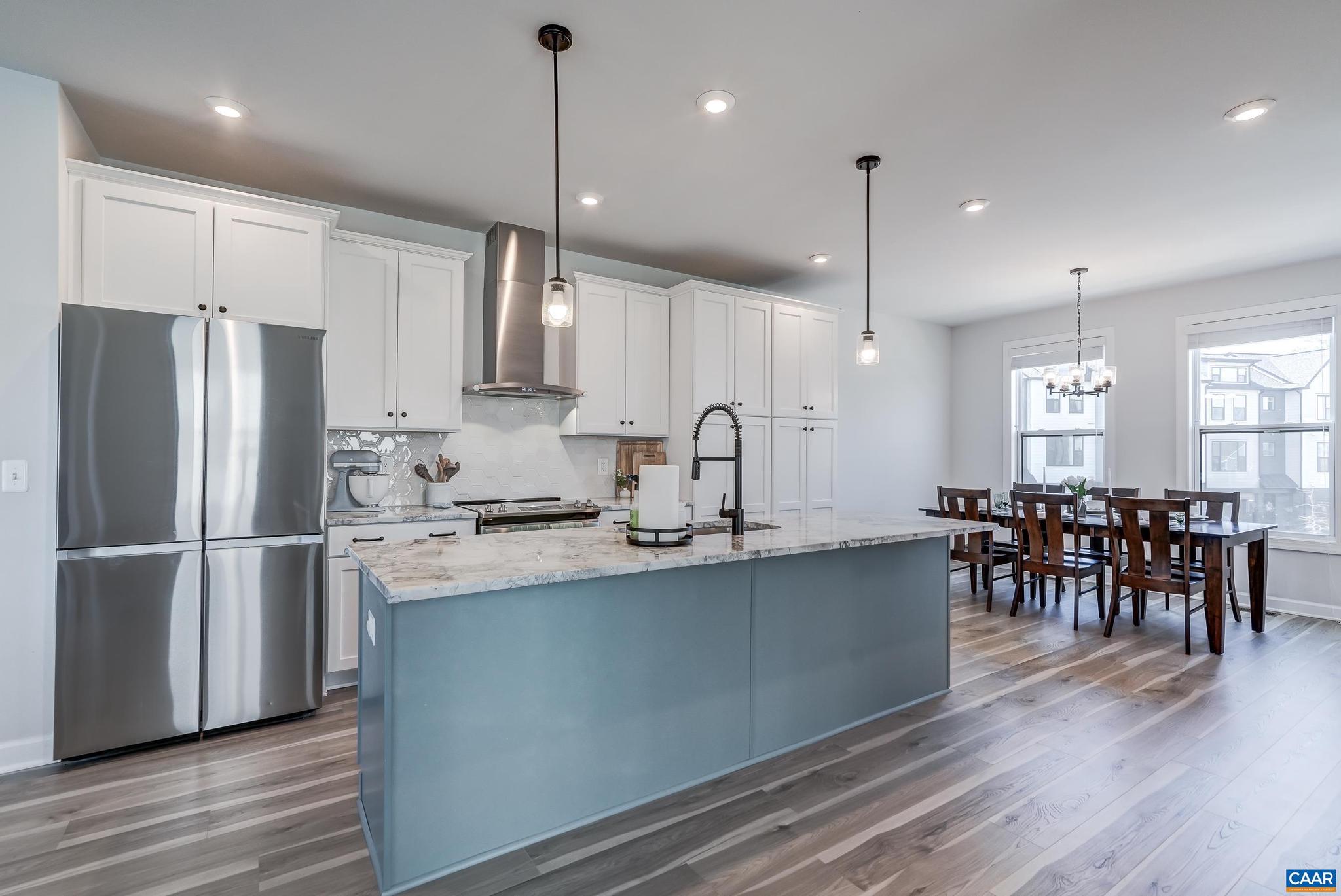 1816 Fowler Street Charlottesville, VA 22901 - Photo 8 of 51 a kitchen with stainless steel appliances granite countertop a refrigerator a stove a sink a center island with wooden floor and cabinets