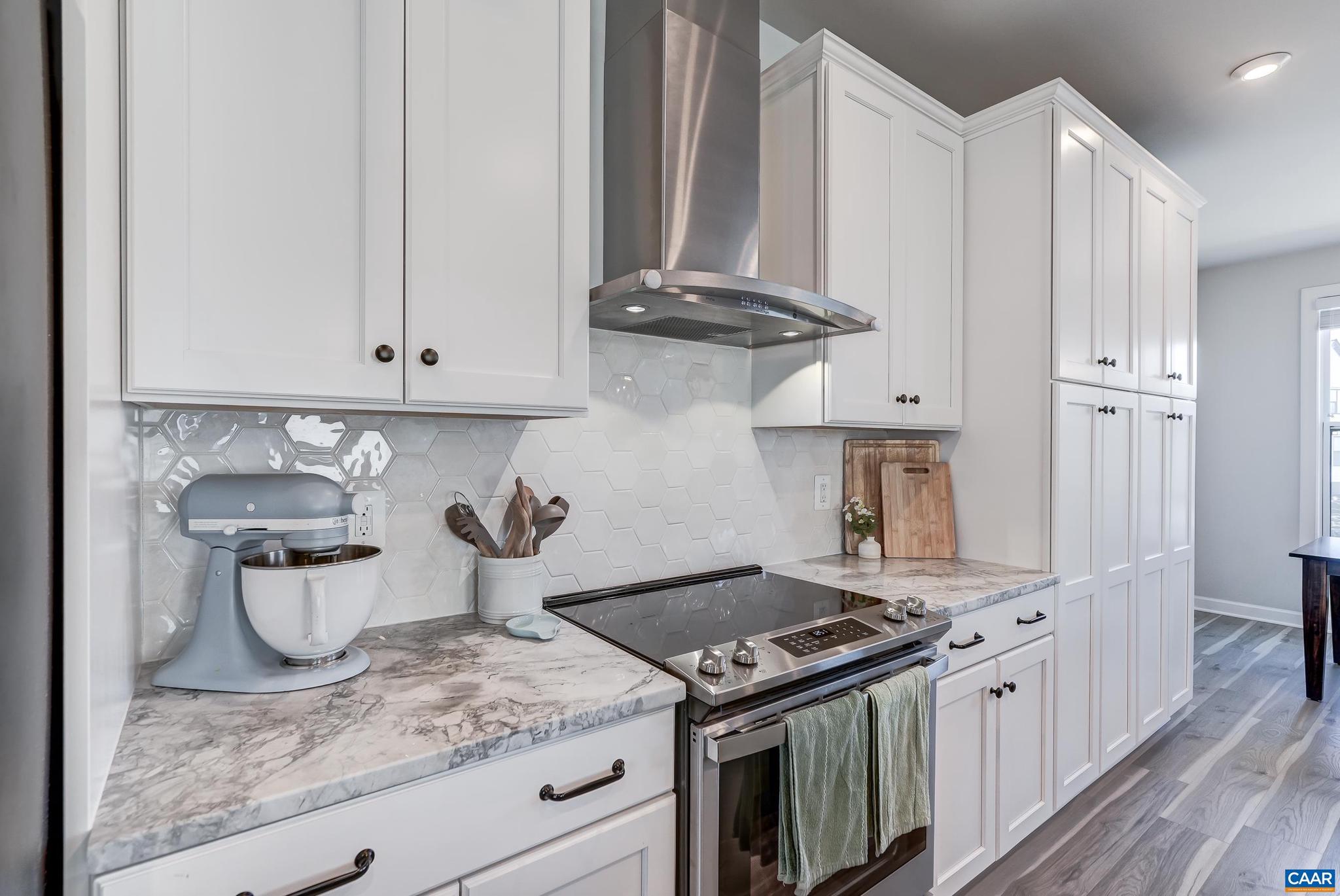 1816 Fowler Street Charlottesville, VA 22901 - Photo 10 of 51 a kitchen with a stove and white cabinets