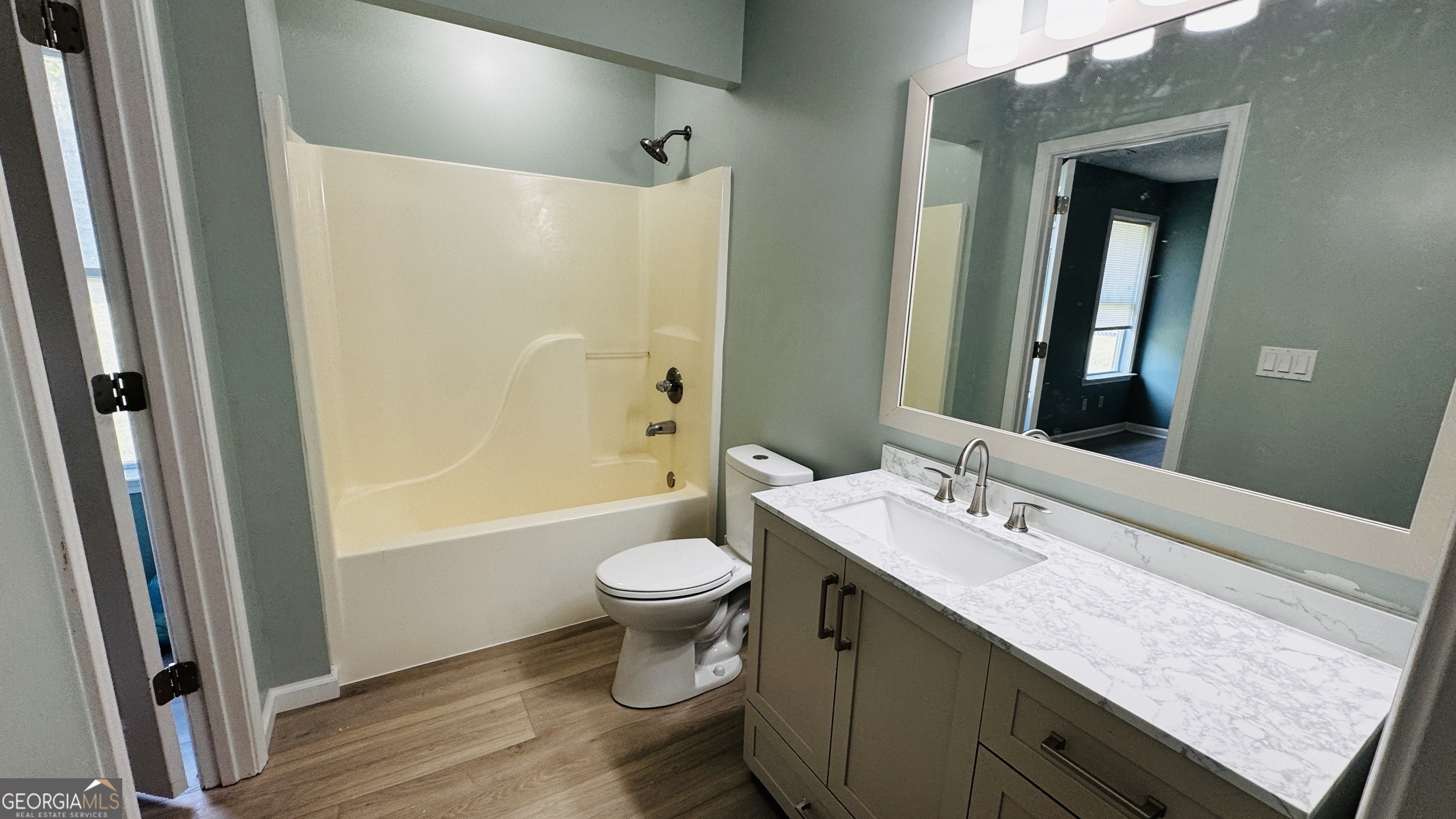 512 Antietum Road Collins, GA 30421 - Photo 9 of 16 a bathroom with a granite countertop sink toilet and shower a mirror