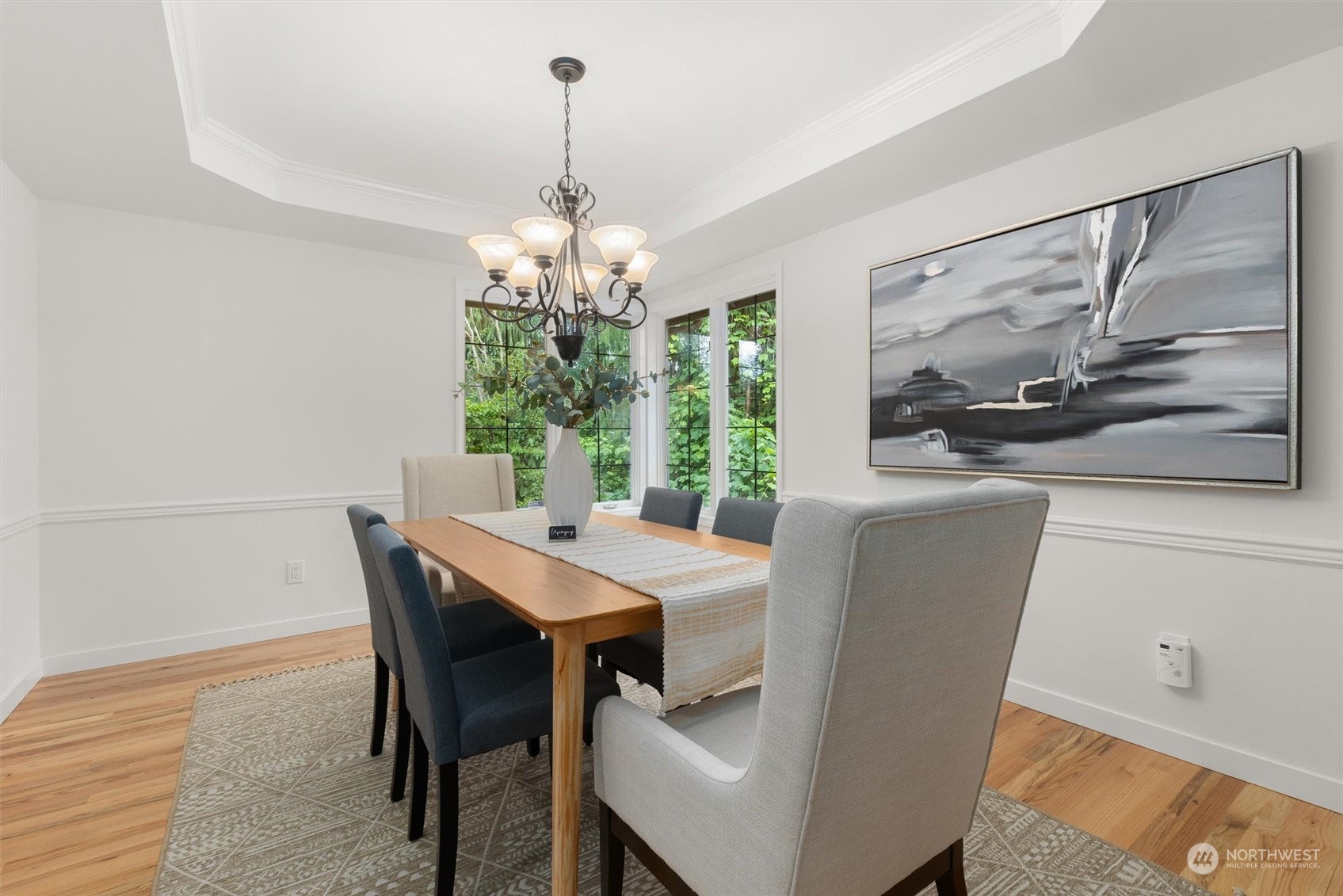 3014 184th Place Southeast Bothell, WA 98012 - Photo 11 of 36 a view of a dining room with furniture a chandelier and wooden floor