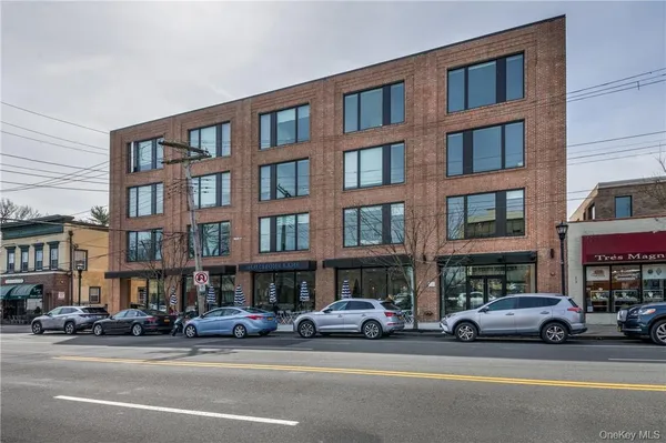 a view of a street that has couple of cars parked on the road