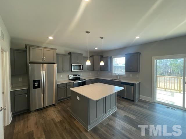 24 Star Valley Dr. Valley Angier, NC 27501 - Photo 17 of 23 a large kitchen with a center island wooden floor stainless steel appliances and a window