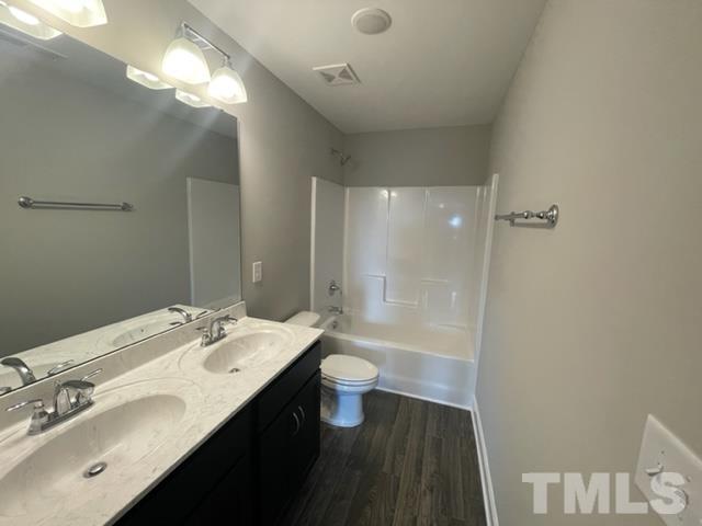 24 Star Valley Dr. Valley Angier, NC 27501 - Photo 5 of 23 a bathroom with a double vanity sink toilet and a mirror
