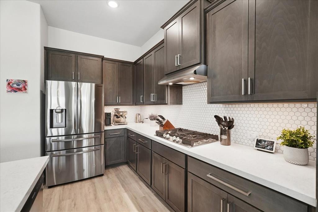 2721 Rotherham Street Prosper, TX 75078 - Photo 6 of 37 a kitchen with stainless steel appliances a sink a stove and refrigerator