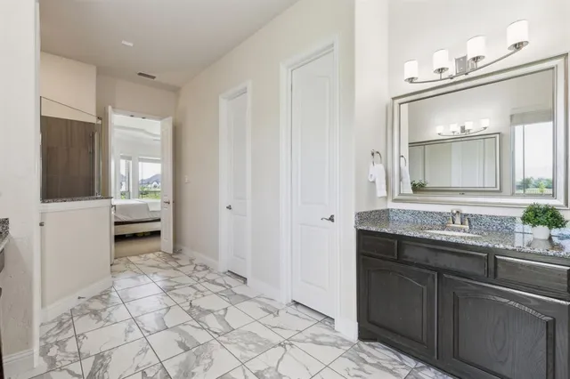 a bathroom with a sink a toilet and mirror