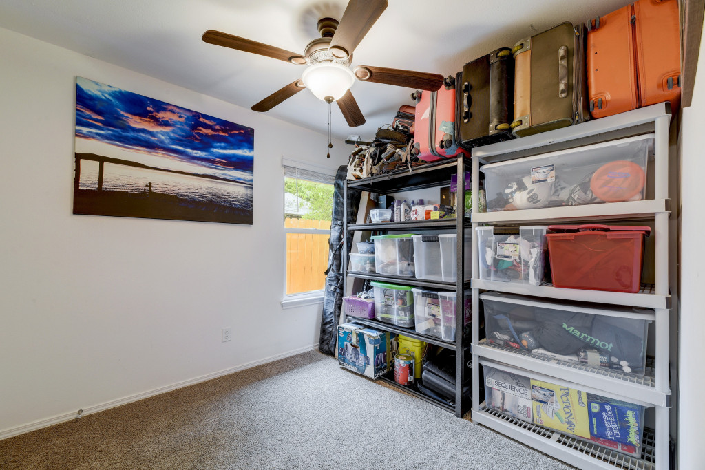 6002 Baton Rouge Drive Austin, TX 78727 - Photo 16 of 20 Carpeted interior room with a ceiling fan light fixture