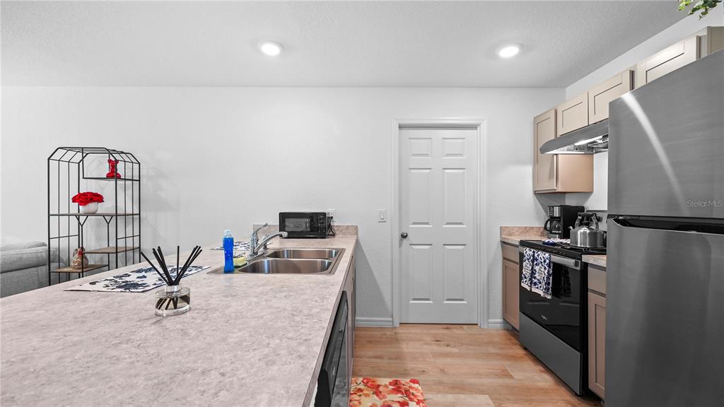 1477 Winthrop Street North Port, FL 34288 - Photo 11 of 100 a kitchen with stainless steel appliances granite countertop a sink dishwasher stove and refrigerator