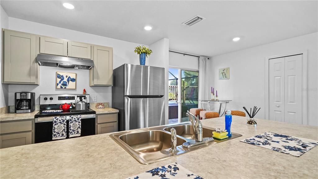 1477 Winthrop Street North Port, FL 34288 - Photo 13 of 100 a kitchen with stainless steel appliances granite countertop a refrigerator and a sink