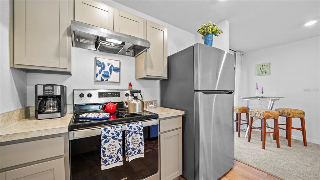 1477 Winthrop Street North Port, FL 34288 - Photo 15 of 100 a kitchen with stainless steel appliances granite countertop a refrigerator and a stove top oven