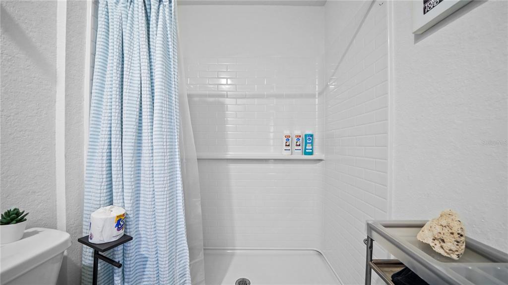 1477 Winthrop Street North Port, FL 34288 - Photo 19 of 100 a bathroom with a shower curtain and a sink