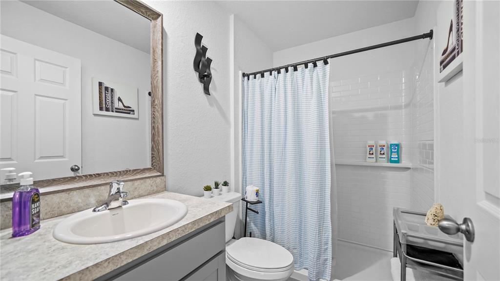 1477 Winthrop Street North Port, FL 34288 - Photo 26 of 100 a bathroom with a granite countertop sink toilet and a mirror