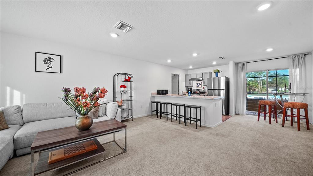 1477 Winthrop Street North Port, FL 34288 - Photo 6 of 100 a living room with furniture and a table