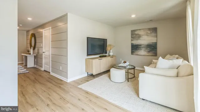 a living room with furniture and flat screen tv