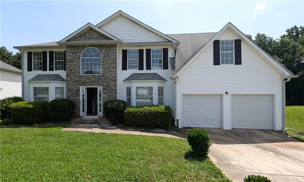 2250 Waters Run Decatur, GA 30035 - Photo 1 of 1 a front view of a house with a yard and garage