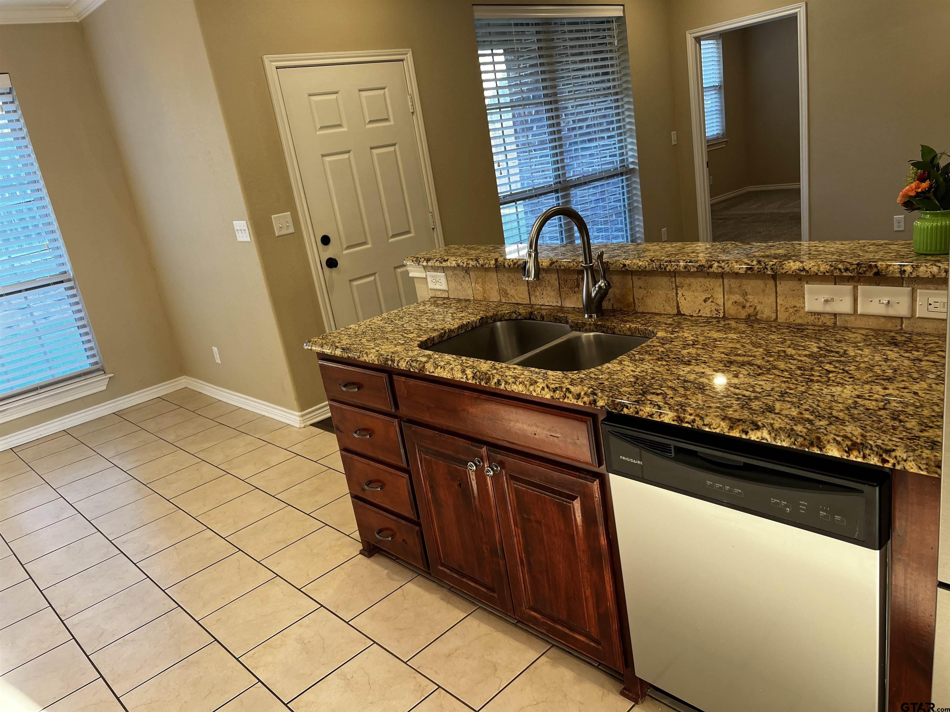 112 Letha Court Tyler, TX 75702 - Photo 12 of 45 a sink with granite countertop cabinets and sink