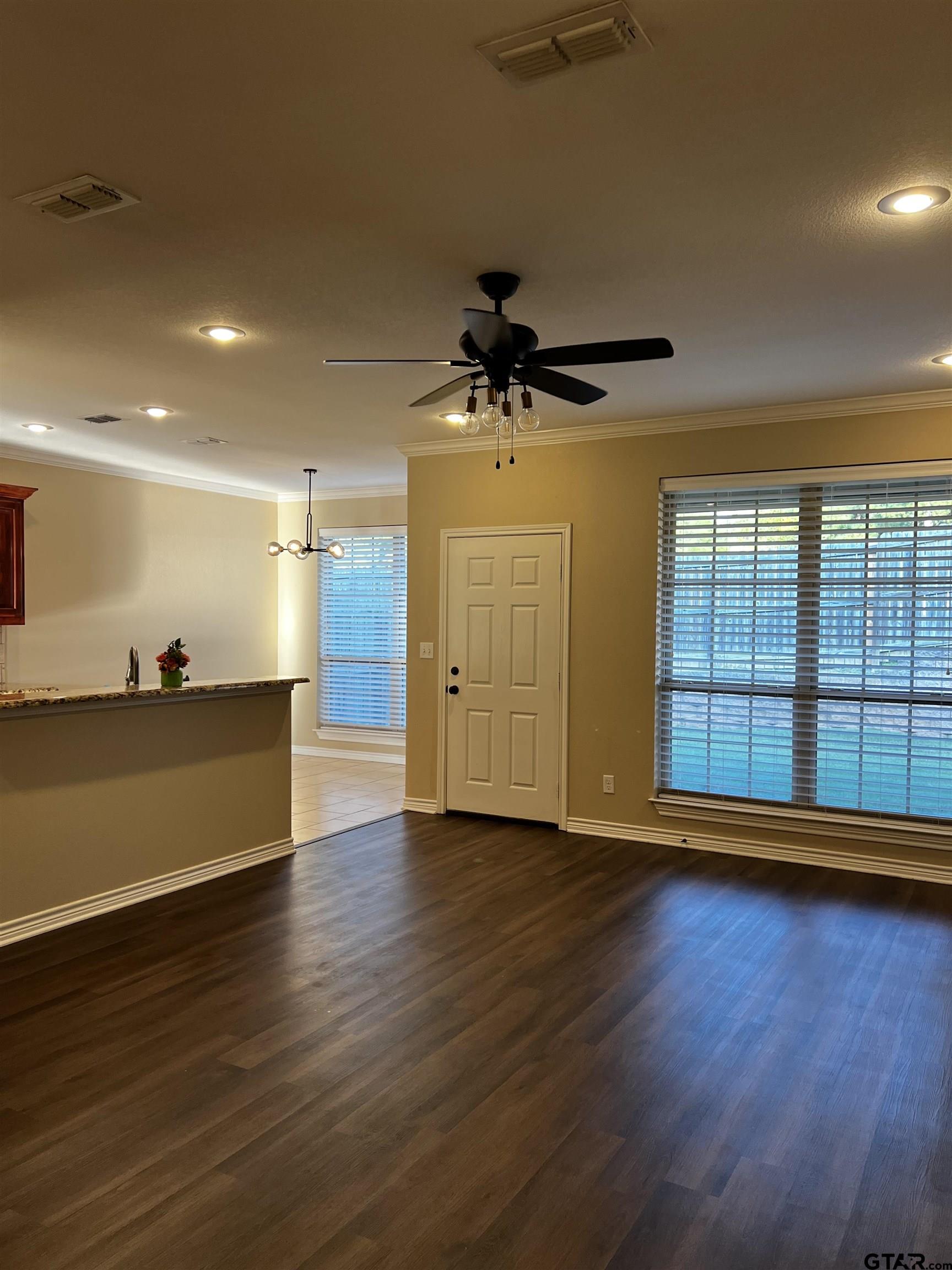 112 Letha Court Tyler, TX 75702 - Photo 15 of 45 a view of a room with wooden floor and a ceiling fan