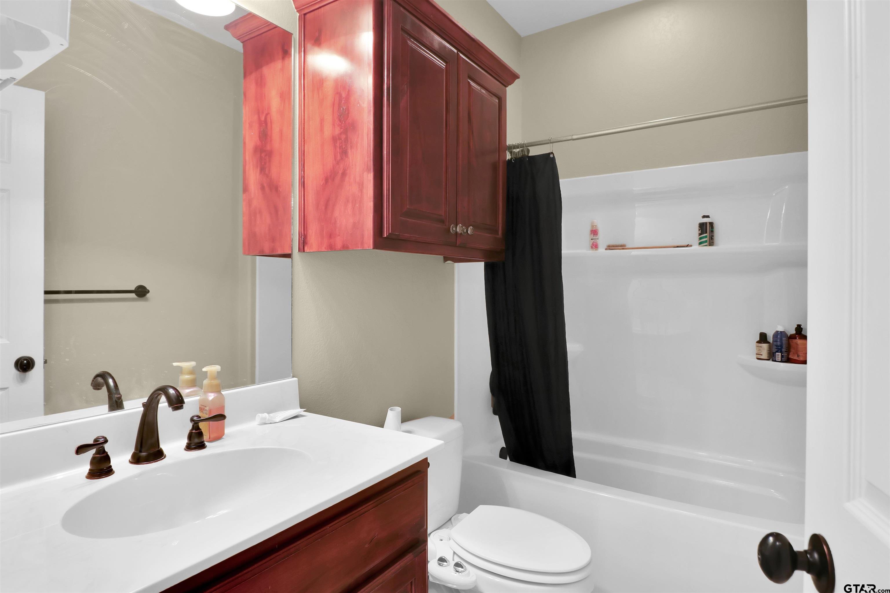 112 Letha Court Tyler, TX 75702 - Photo 2 of 45 a bathroom with a sink a toilet and shower
