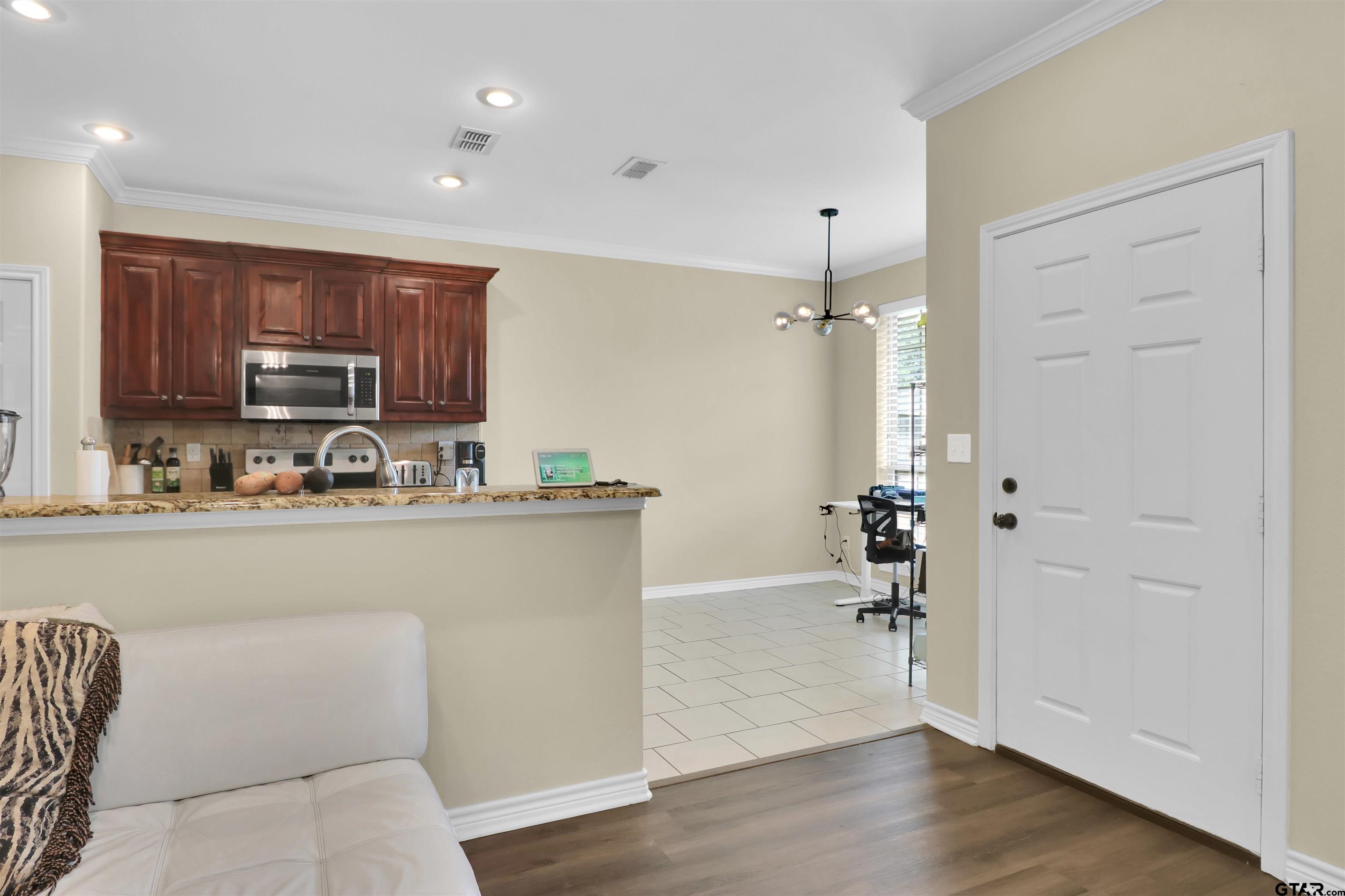 112 Letha Court Tyler, TX 75702 - Photo 38 of 45 a room with stainless steel appliances a refrigerator and a microwave