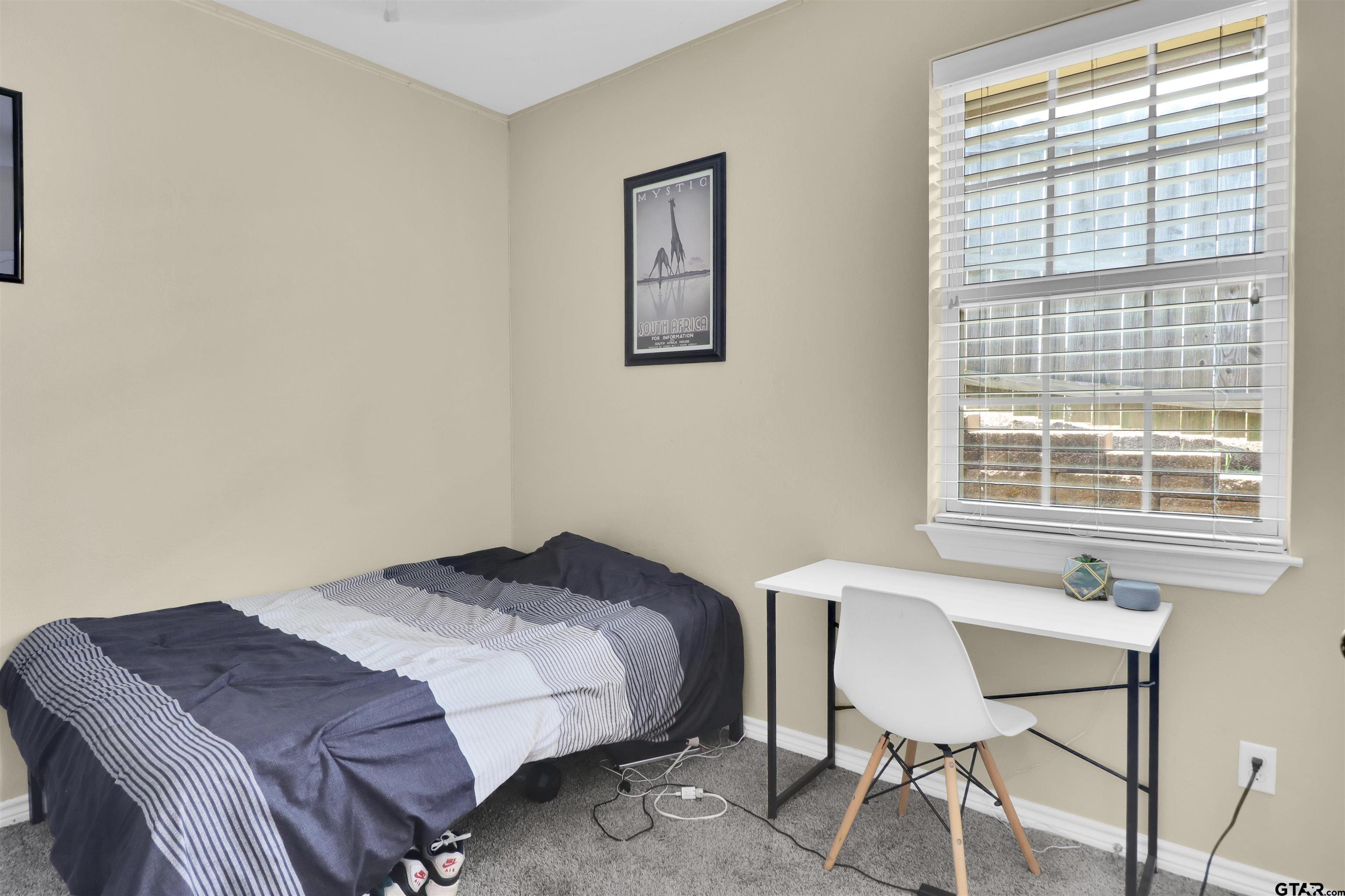 112 Letha Court Tyler, TX 75702 - Photo 6 of 45 a bedroom with a bed and a window