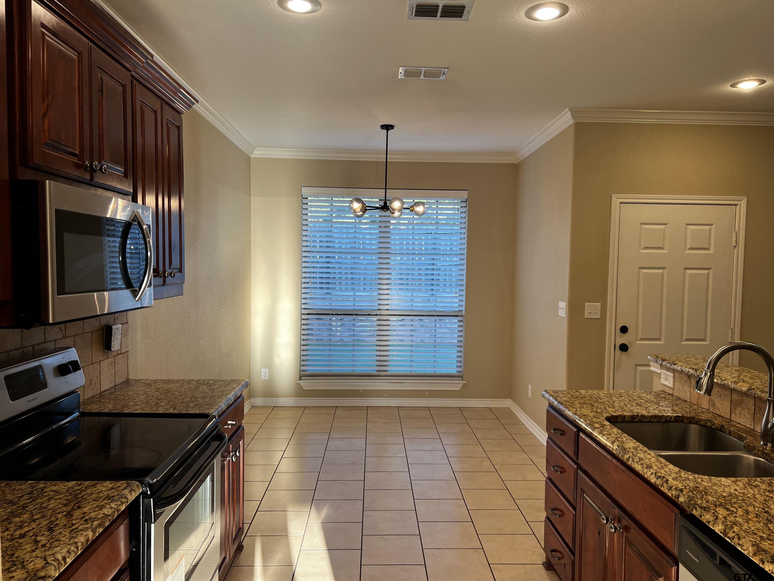 112 Letha Court Tyler, TX 75702 - Photo 9 of 45 a kitchen that has a sink and a stove in it