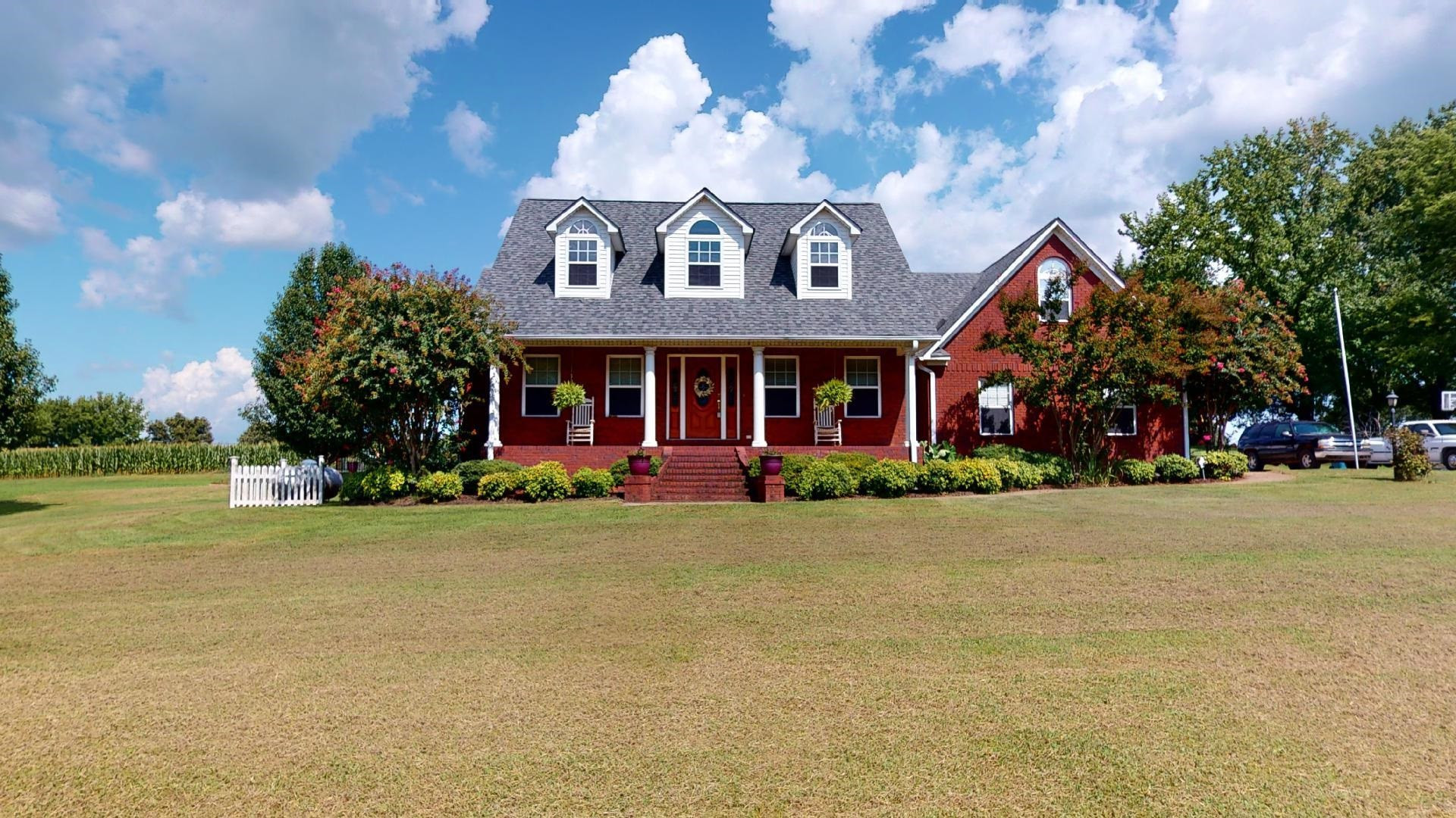 a front view of a house with garden