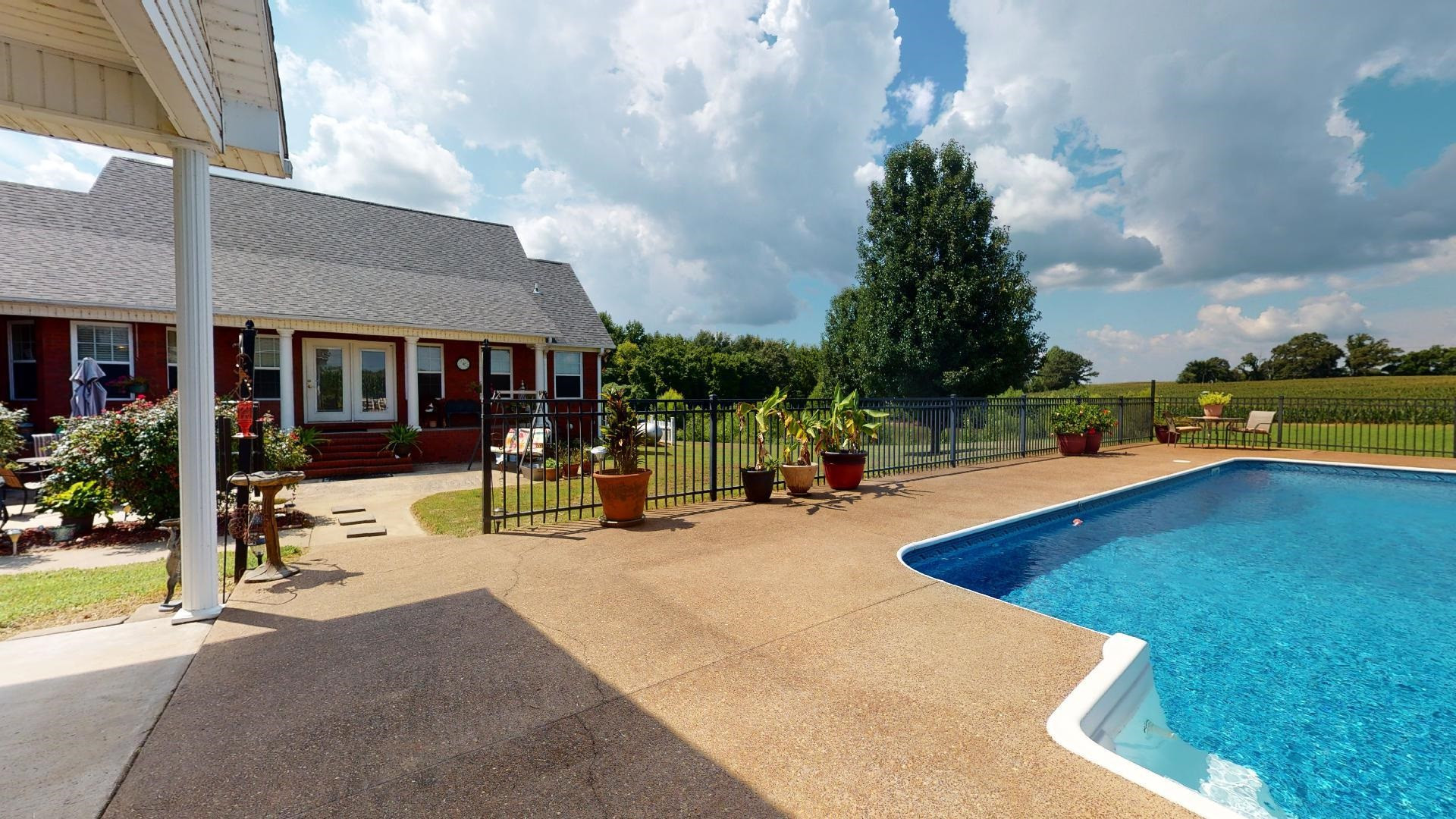 50 Bobby Thompson Road Newbern, TN 38059 - Photo 24 of 26 a view of swimming pool with lawn chairs and plants