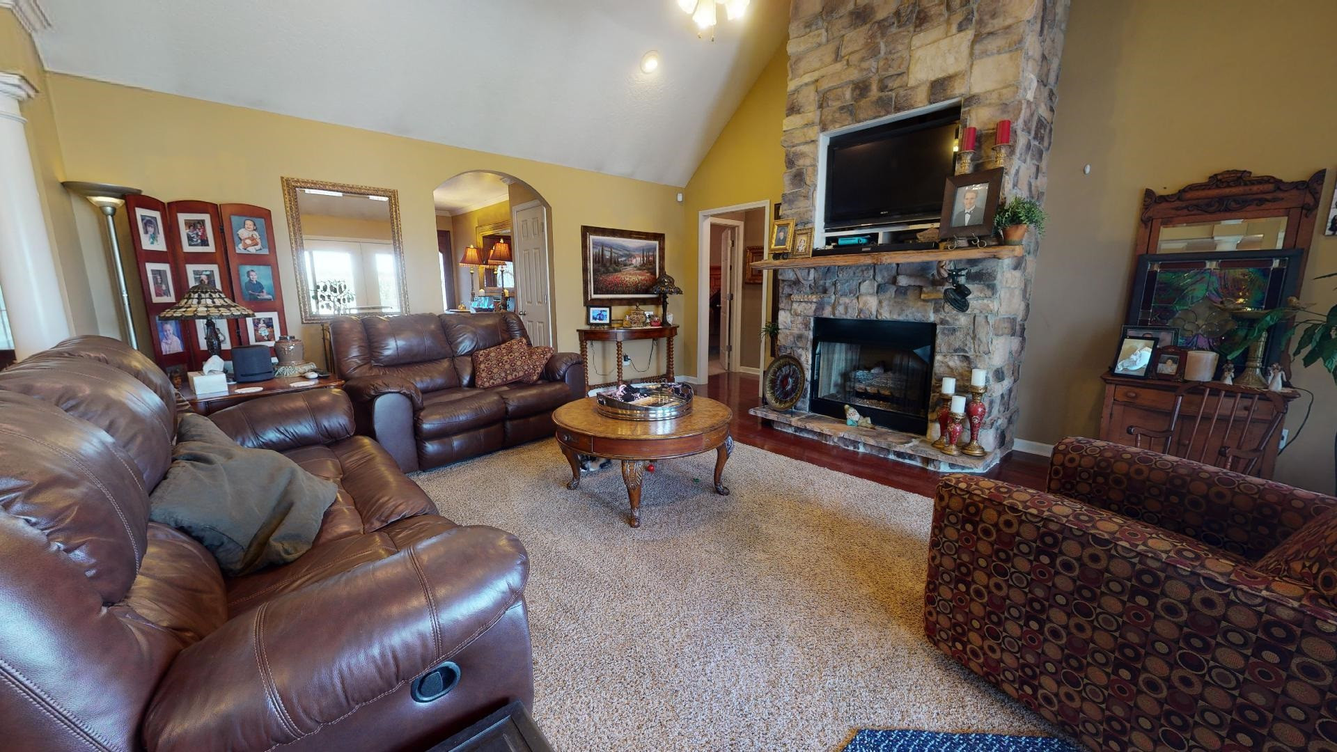 50 Bobby Thompson Road Newbern, TN 38059 - Photo 3 of 26 a living room with furniture a flat screen tv and a fireplace