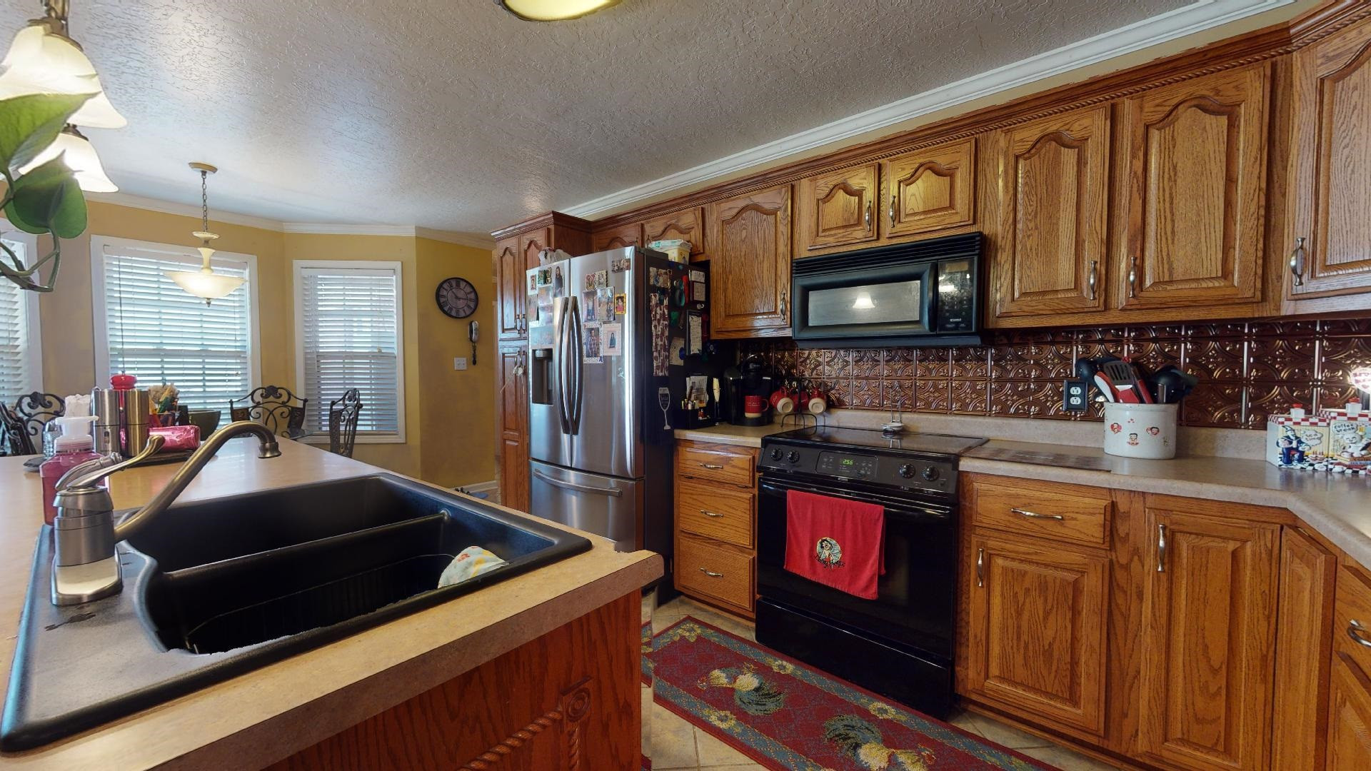 50 Bobby Thompson Road Newbern, TN 38059 - Photo 8 of 26 a kitchen with stainless steel appliances granite countertop a stove and cabinets