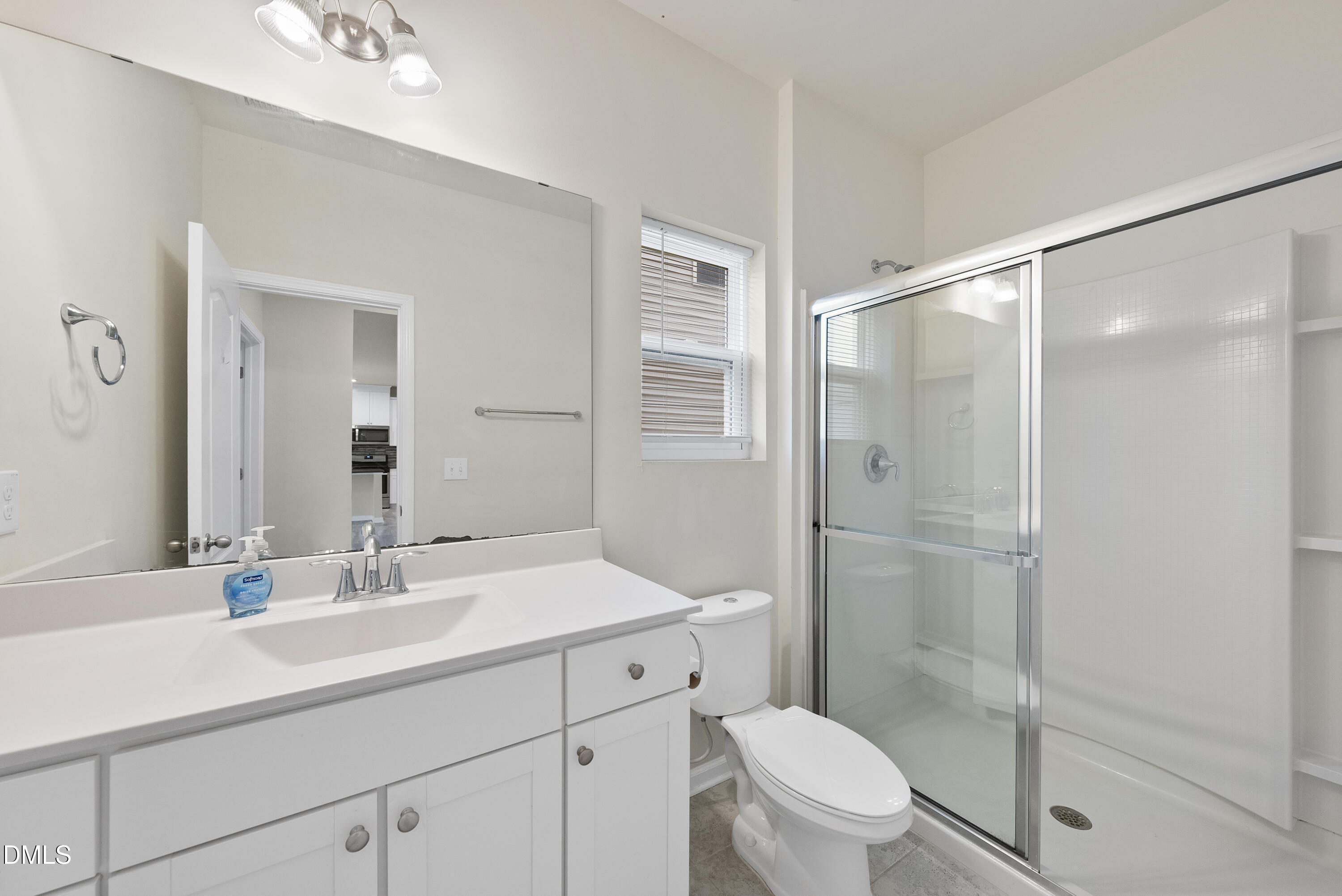 905 Lippincott Road Durham, NC 27703 - Photo 13 of 24 a bathroom with a shower sink vanity mirror and toilet