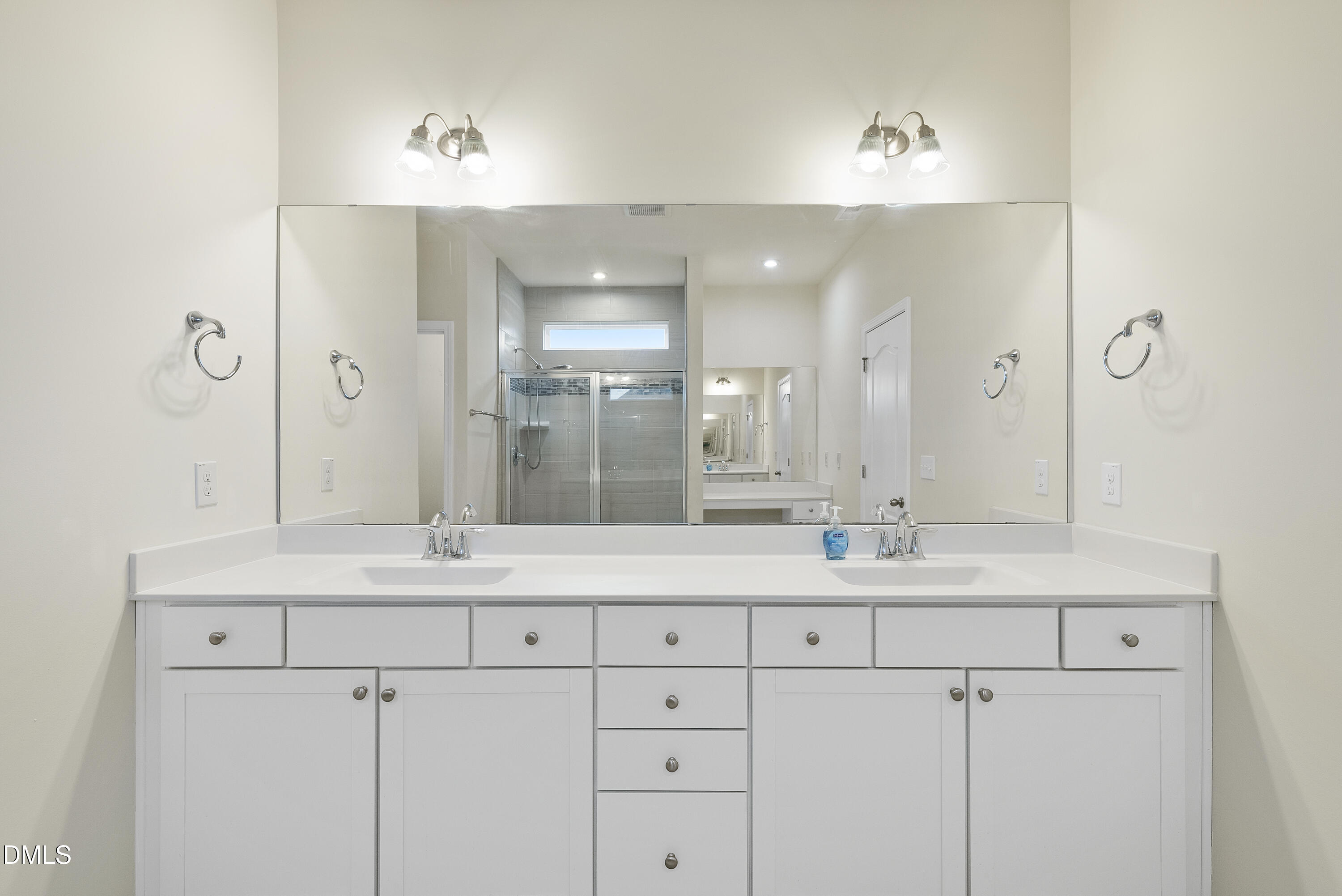 905 Lippincott Road Durham, NC 27703 - Photo 17 of 24 a bathroom with a sink double vanity and a mirror