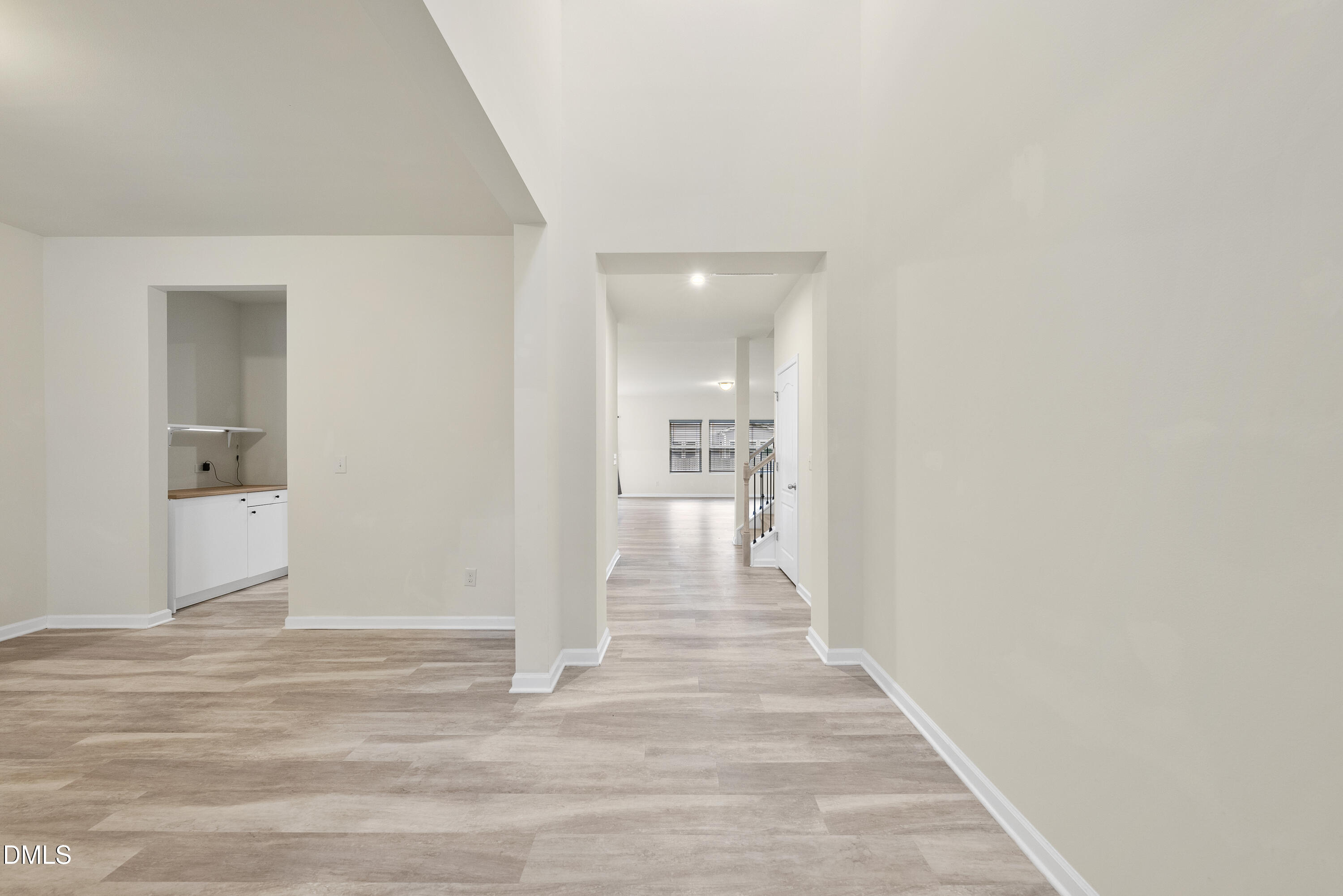 905 Lippincott Road Durham, NC 27703 - Photo 2 of 24 a view of a hallway with wooden floor and a bathroom space