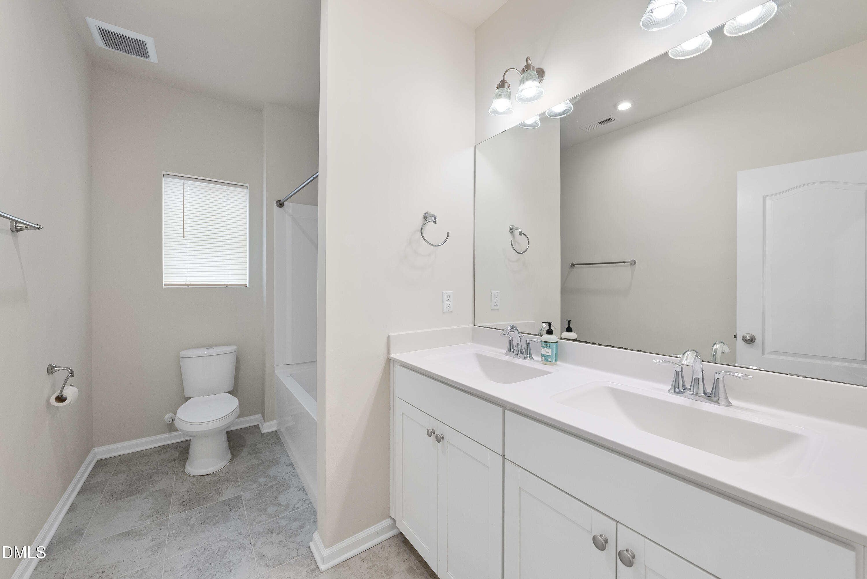 905 Lippincott Road Durham, NC 27703 - Photo 21 of 24 a bathroom with a sink a toilet and a mirror