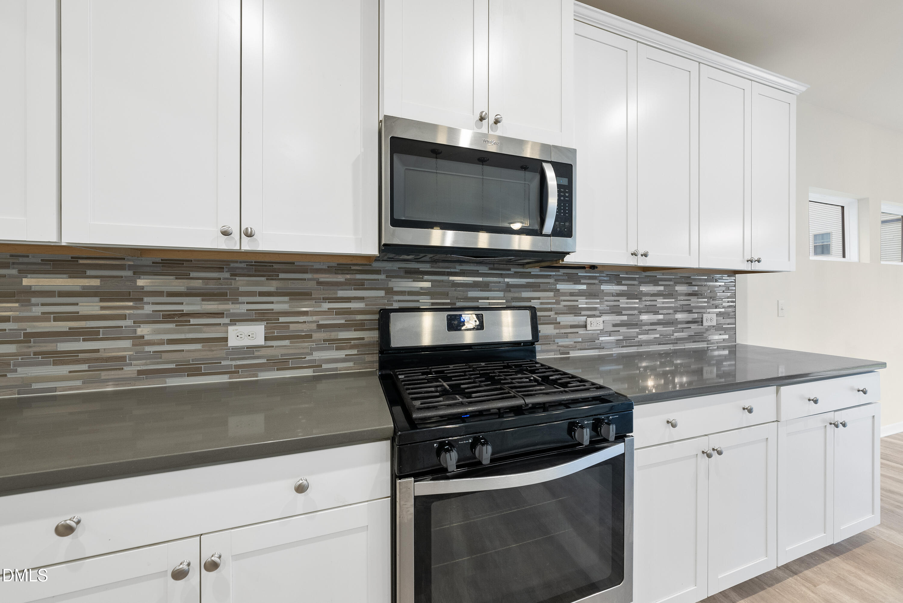 905 Lippincott Road Durham, NC 27703 - Photo 5 of 24 a kitchen with stainless steel appliances granite countertop white cabinets and a stove a oven with white countertops