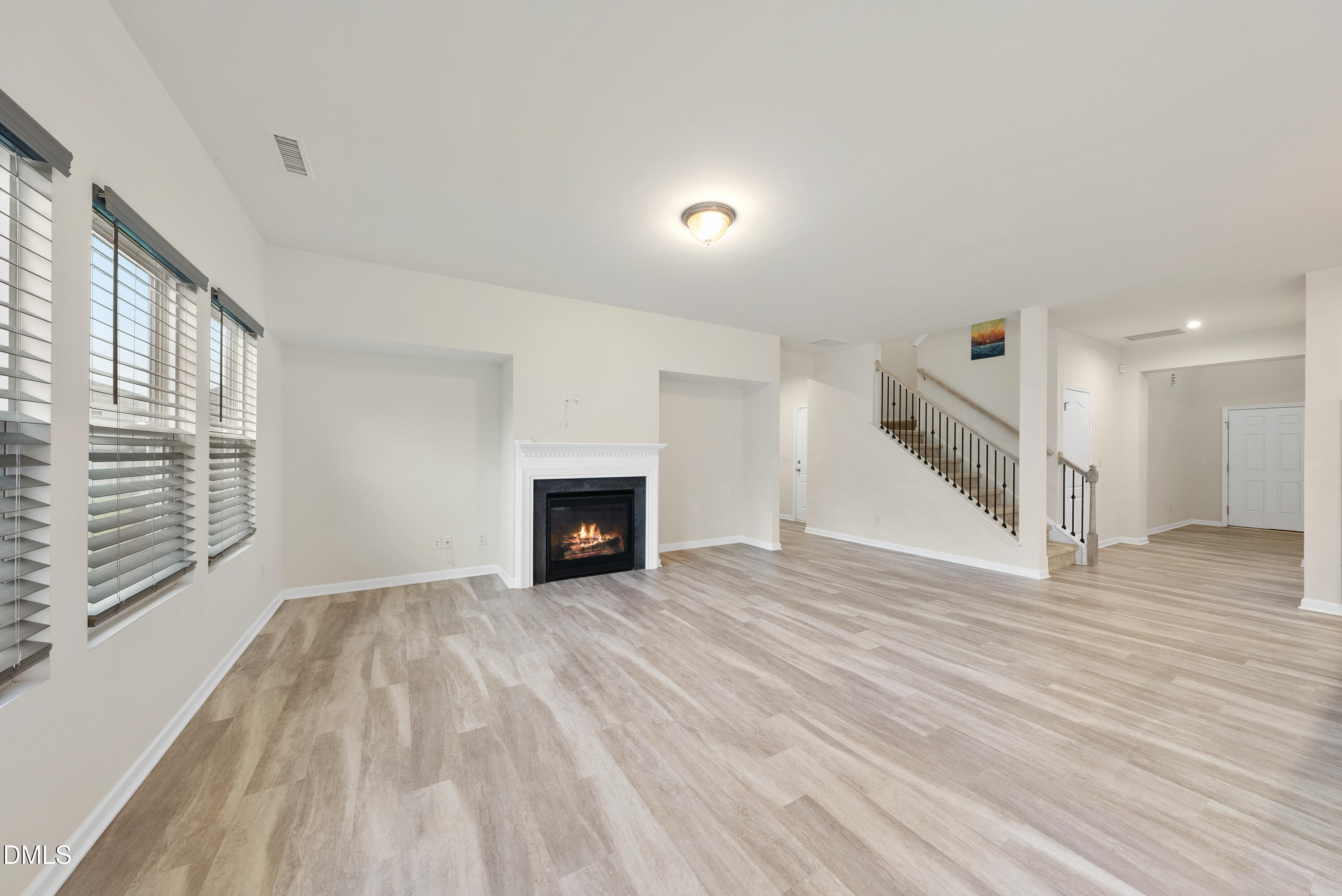 905 Lippincott Road Durham, NC 27703 - Photo 10 of 24 a view of an empty room with wooden floor and a window