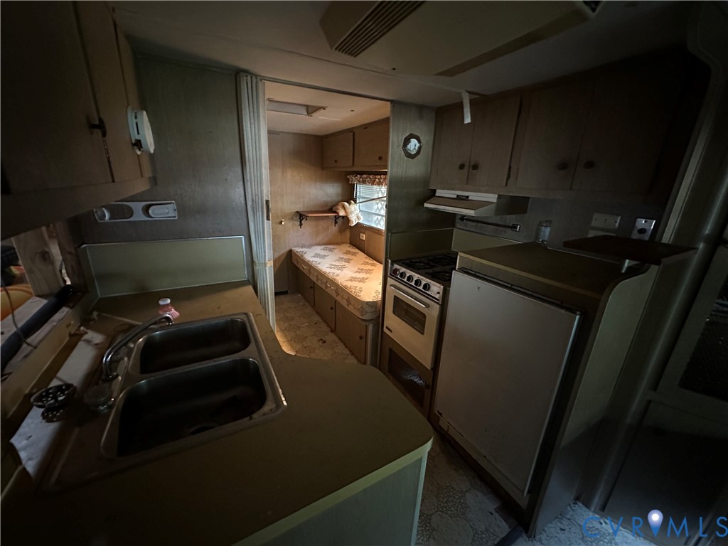 421 Happy Trail Bracey, VA 23919 - Photo 18 of 22 Kitchen with under cabinet range hood and white ra